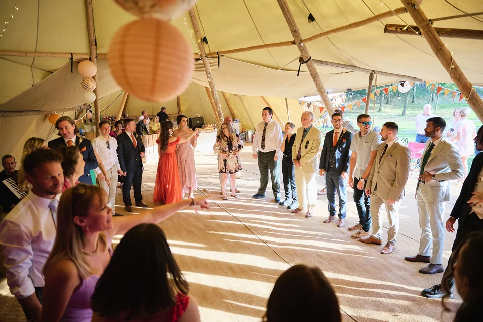 Guests gathered outside the wedding tipi