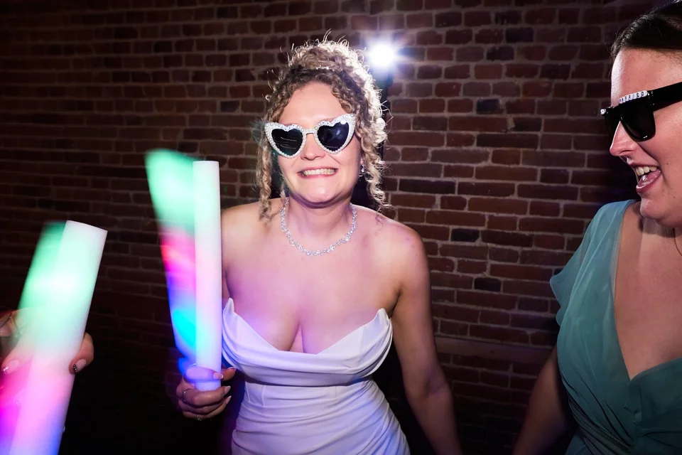 The bride wearing sunglasses on the dance floor