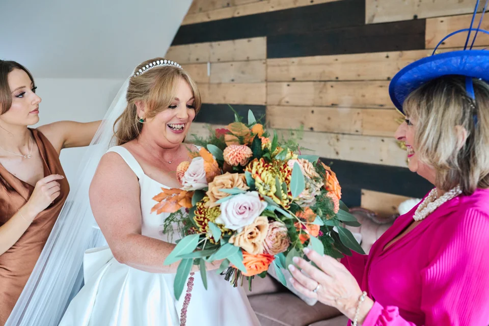 The bride smiling with her bouquet before the ceremony