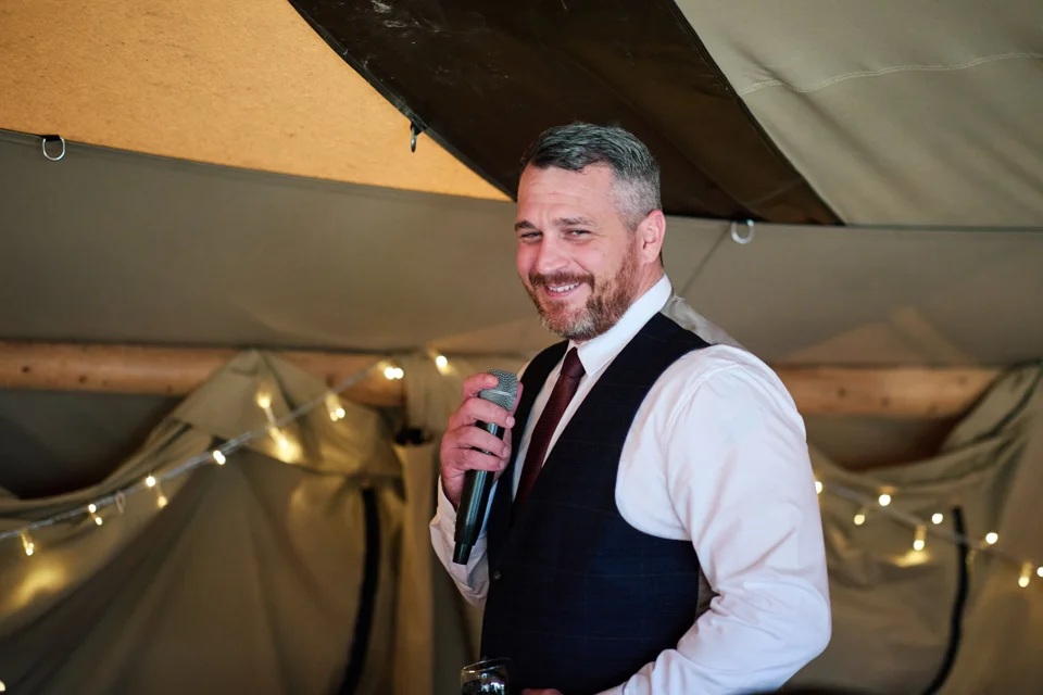 The groom speaking at the reception